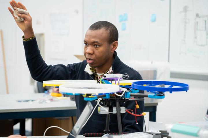 Kenechukwu Mbanisi, assistant professor of robotics engineering at Olin, is shown in a classroom.