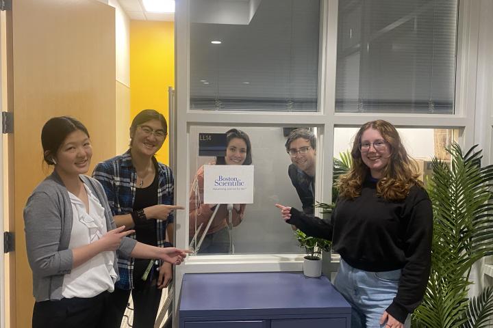 Boston Scientific SCOPE Team 2024 Five students pointing to a sign for Boston Scientific