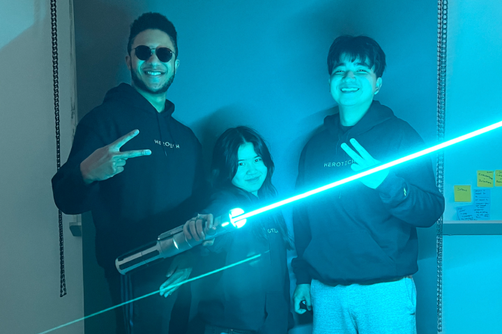 Hero Tech Team picture with lightsaber - Aaron, Madie, and Jacob (left to right)