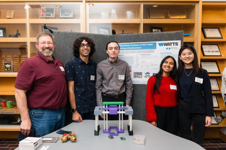 Watts Water SCOPE Team 2024 Summit Students posing in front of project poster with liaison