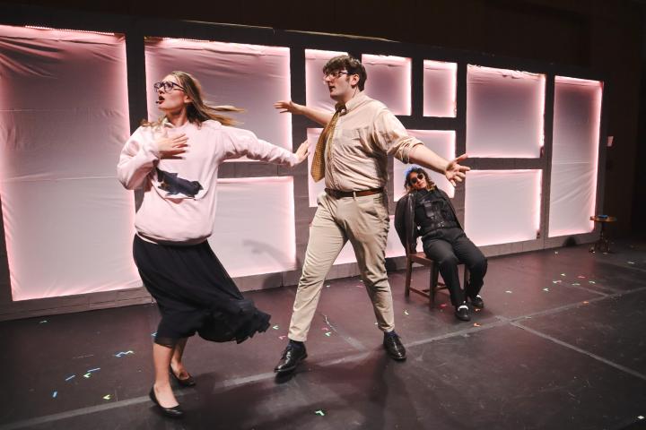 Three Olin College theatre students perform on stage.