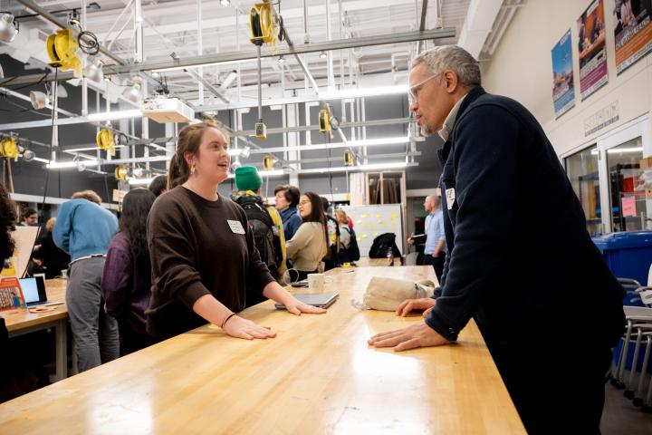 Declan K. '24 is seen talking with an ADE Showcase attendee at the Weismann Foundry.