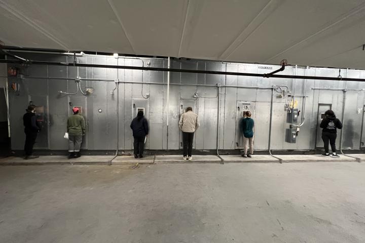 Students looking at HVAC system