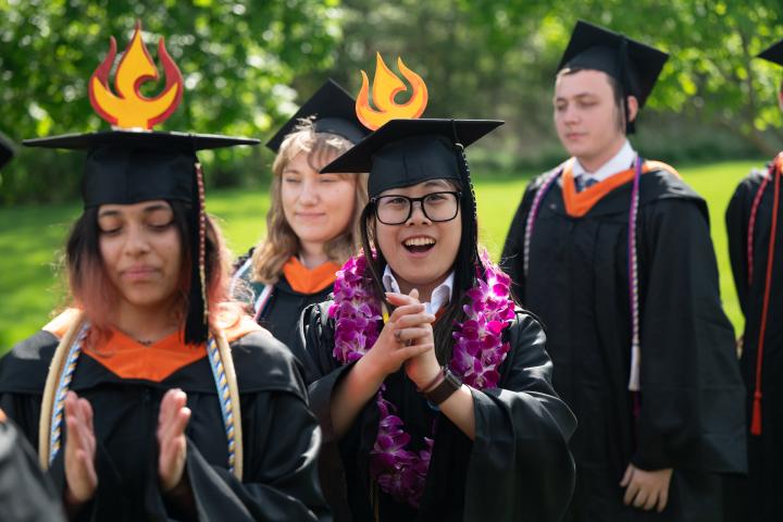 Graduates from the Olin Class of 2025 clap while waiting to receive their degrees at Commencement on May 16, 2025.