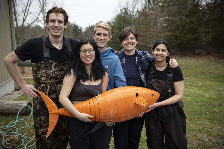 Student project team around their robot