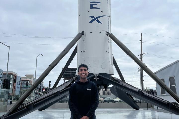 Charith Fernando '27 Student Charith Fernando '27 posing in front of SpaceX rocket.
