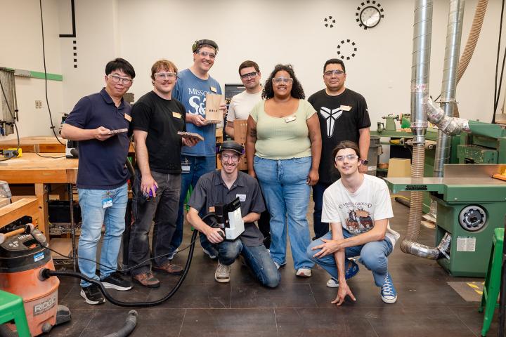Makerspace Institute participants pose for a group photo in one of the Shop spaces at Olin College.