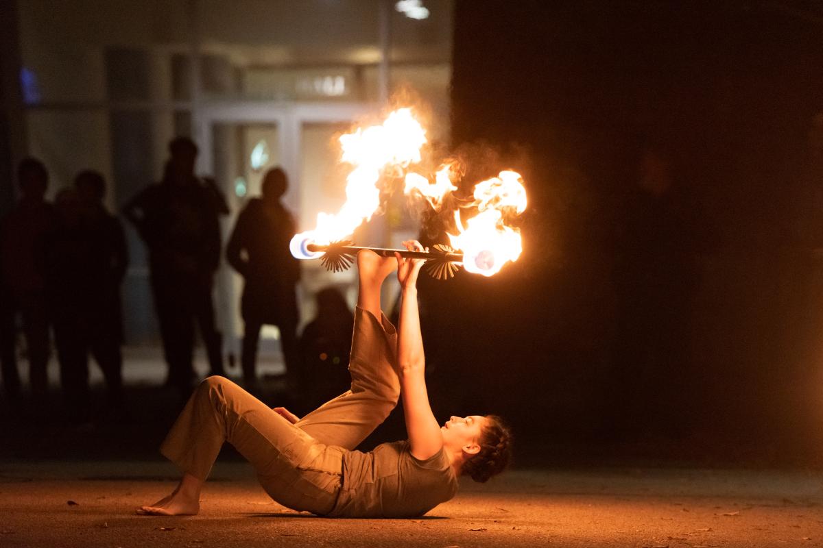 A photo of a person spinning fire poi