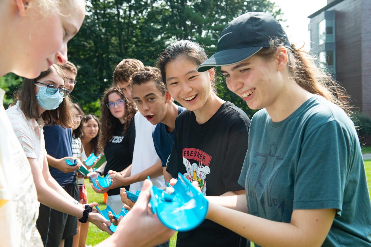 A group of students working together to build a contraption at orientation