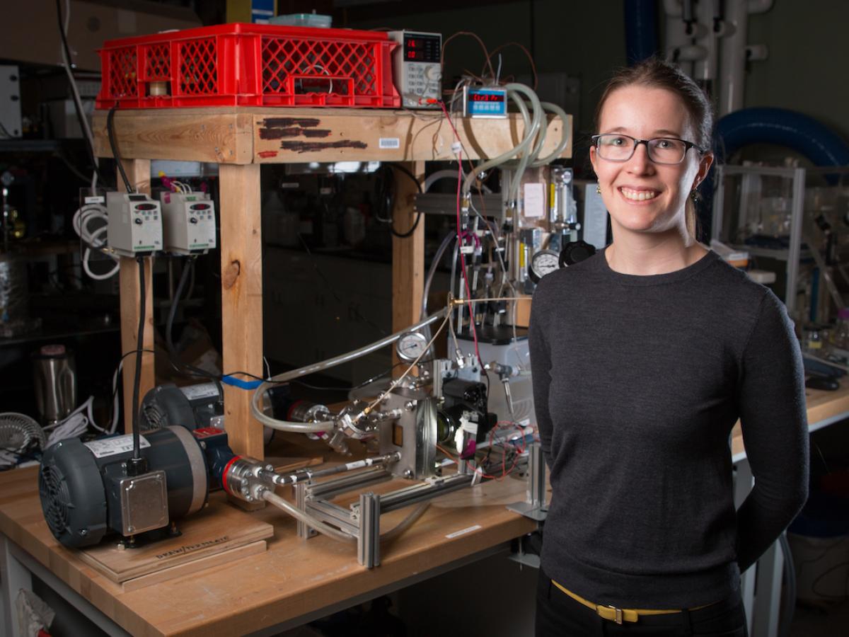 A photo of professor Emily Tow standing with her desalination system