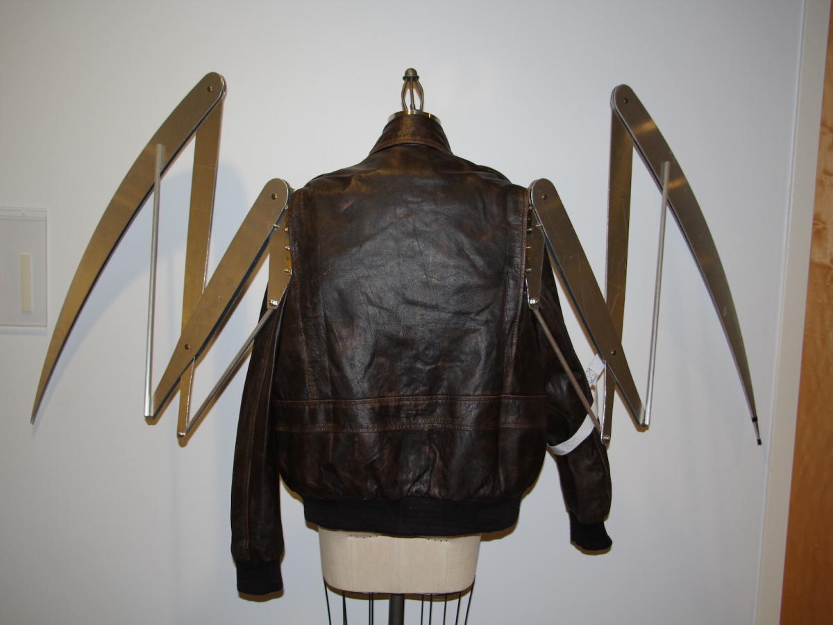 A brown leather bomber jacket with a 13-foot wide wingspan attached to its back.