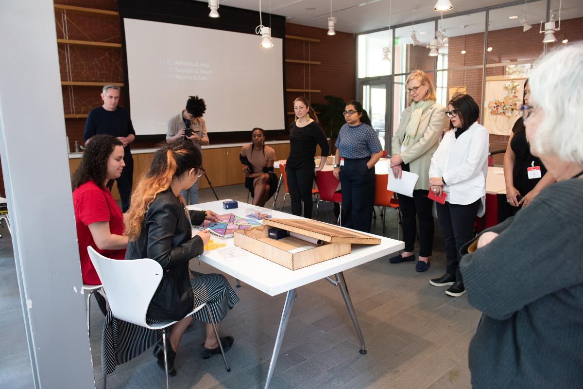 A photo of a group of people standing near a table