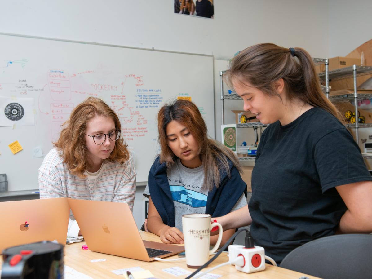 Three student researchers, including Berwin Lan '24 in the center, work on the tech platform project. Three student researchers, including Berwin Lan '24 in the center, work on the tech platform project.