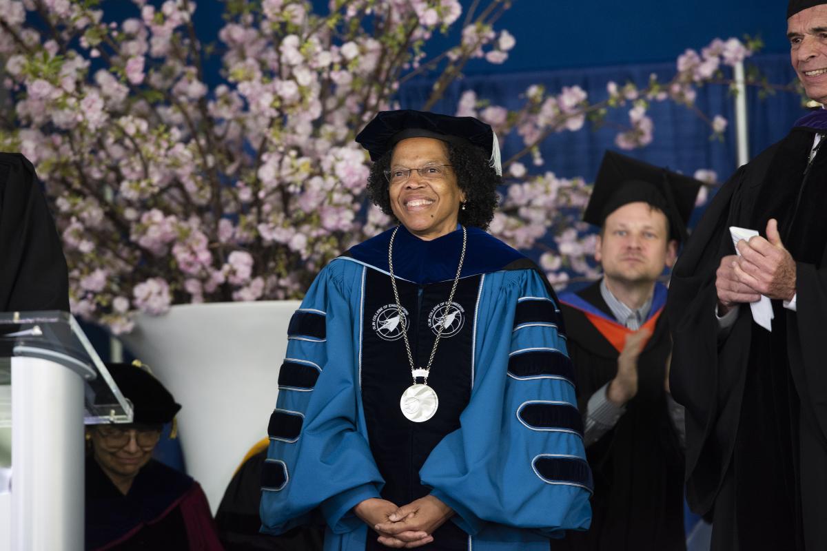 President Gilda A. Barabino sits on the stage in regalia during Inauguration ceremonies on May 5, 2022. 