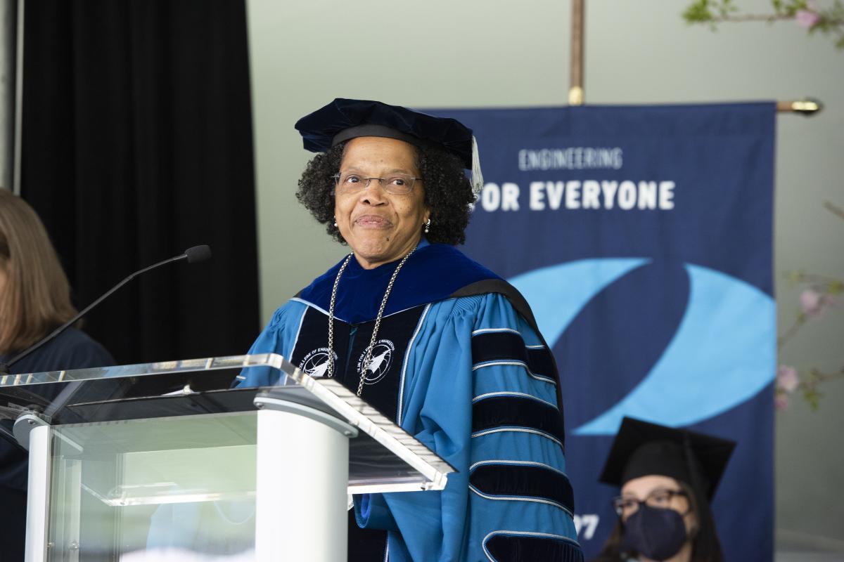 President Gilda A. Barabino stands at the podium in regalia during Inauguration ceremonies on May 5, 2022. 