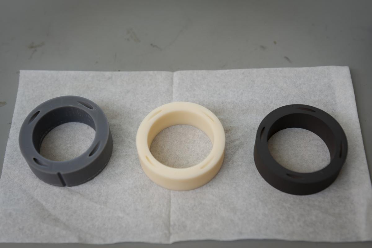 A set of three diffuser prototypes laying on a table. A set of three rings (officially named diffuser prototypes) laying on a table.