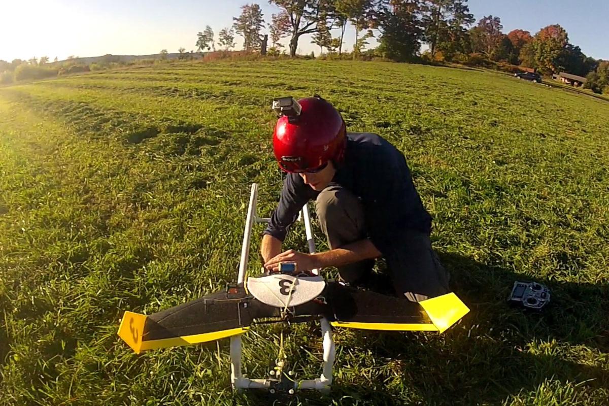 Andy Barry '10 works on an autonomous drone in the field. Andy Barry '10 works on an autonomous drone in the field.