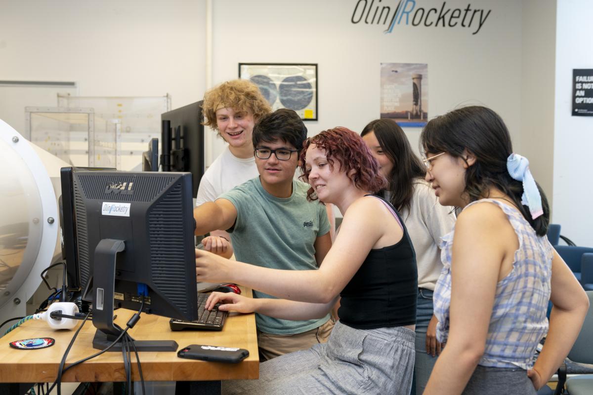 Summer Research, five students looking at computer