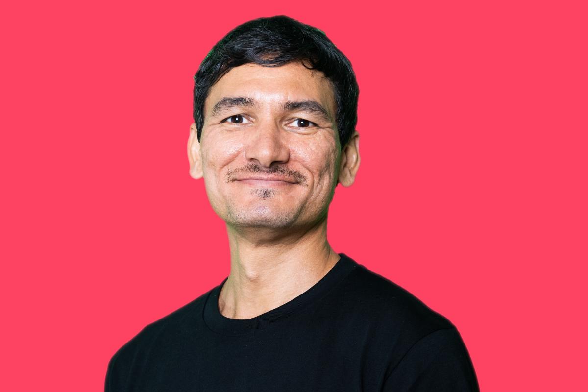 Keoni Mahelona portrait on red background 