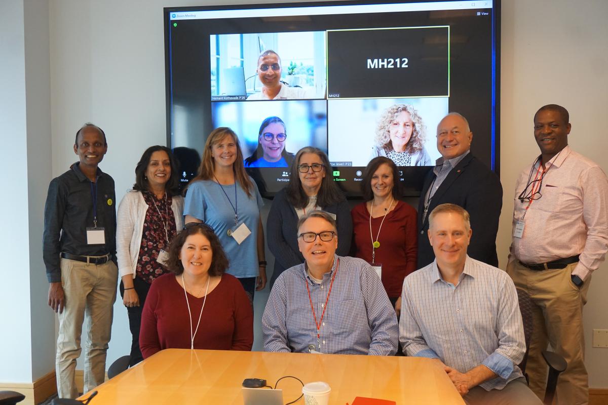 The FY 23 Olin College Parent Leadership Council A photo of a group of men and women in a conference room