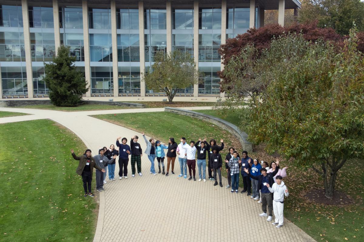 Olin 2023 Mix & Mingle Fly-In Drone Photo Group of students in the OVAL greenspace waving for a drone photo