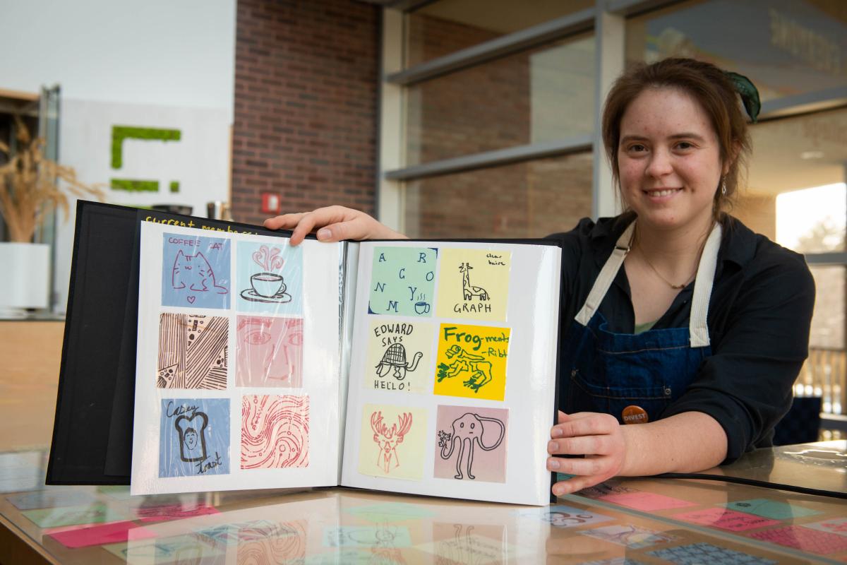Declan Ketchum '24 displays the ACRONYM sticky notes binder in Milas Hall.