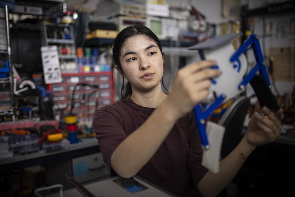 An Olin College student works with her hands in a lab on campus. An Olin College student works with her hands in a lab on campus.