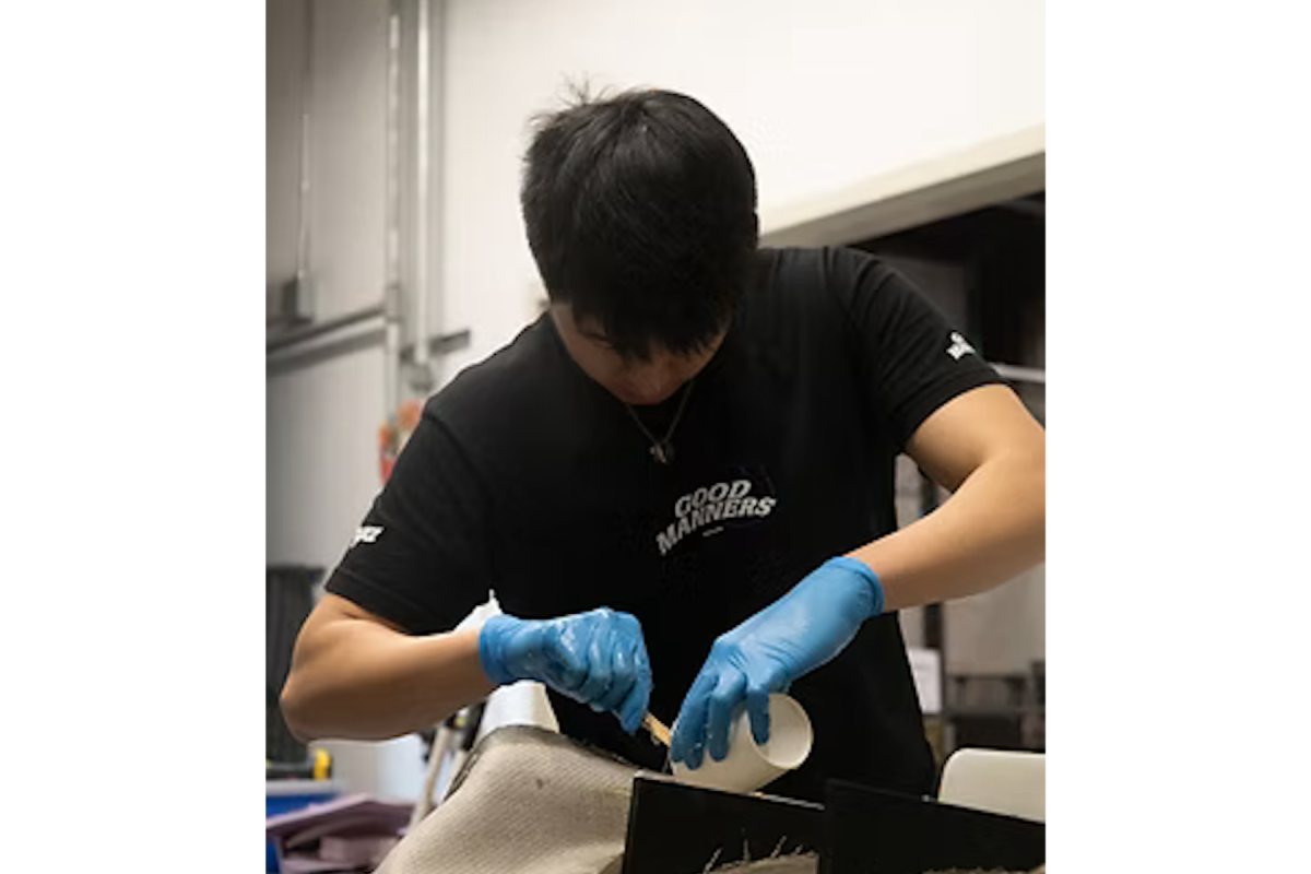 Jonathan Sun '28 works on a rear diffuser in the Olin Shop. Jonathan Sun '28 works on a rear diffuser in the Olin Shop.
