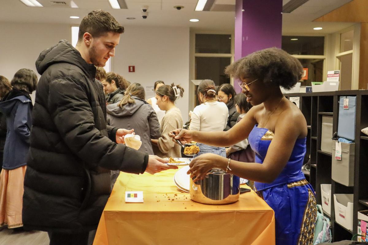 A student is served some traditional jollof rice from Ghana at the Olin College Multicultural Fair.