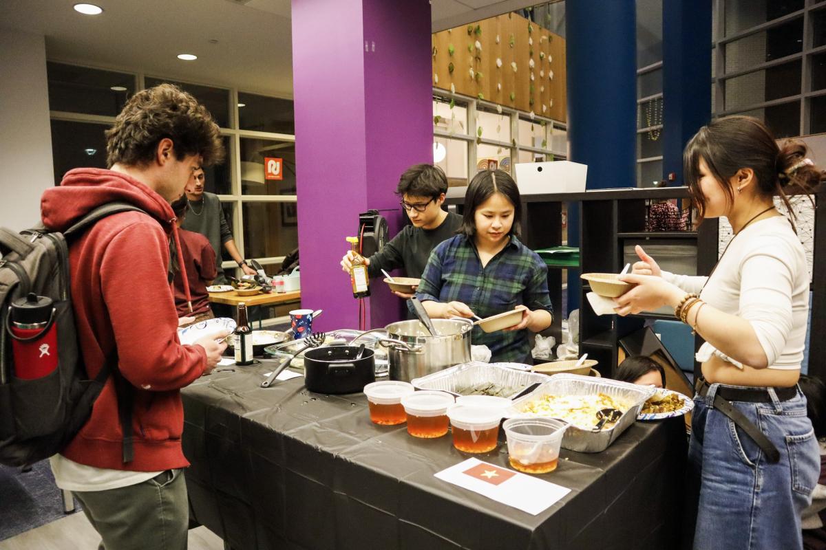 Students serve their dishes at the Olin Multicultural Fair.