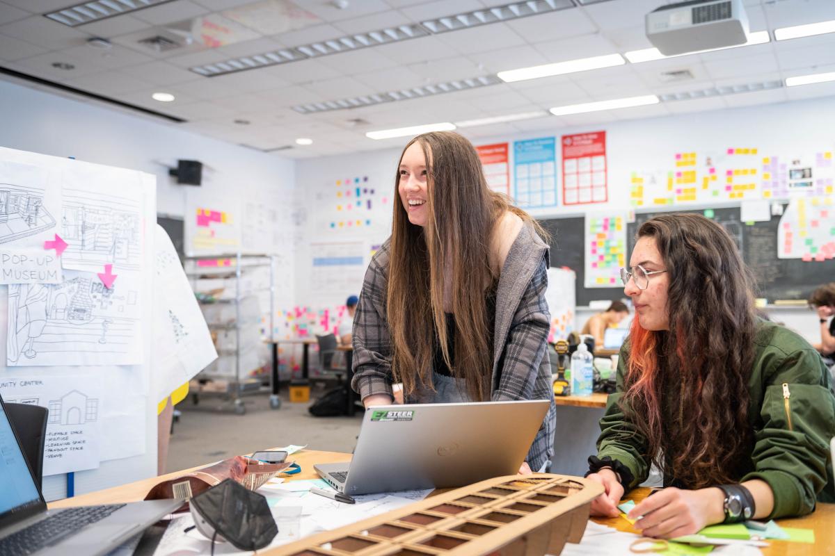 Two students engage in a classroom project.