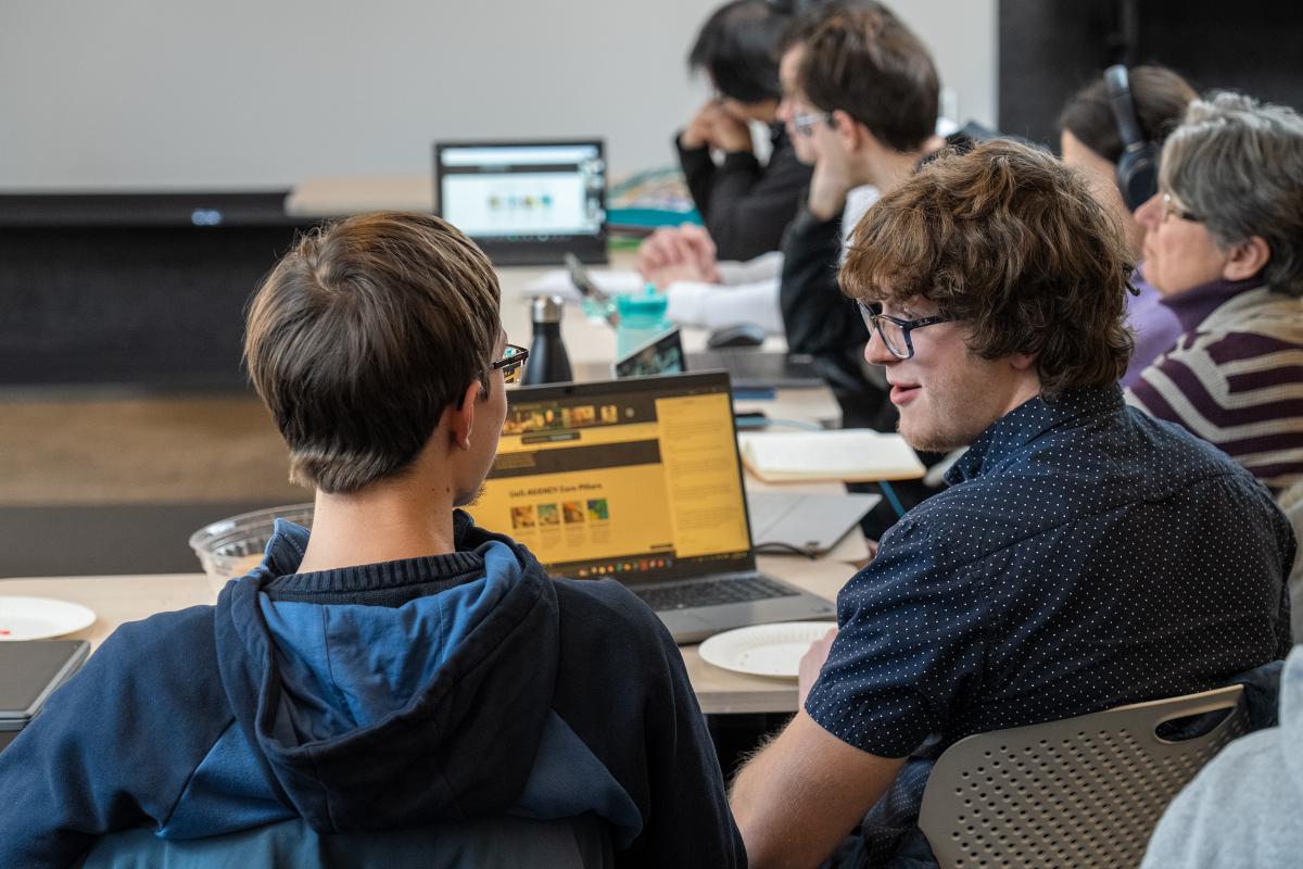 Timur Gray '28 talks with a hackathon teammate at the MIT-Ukraine "Build for Ukraine" hackathon.