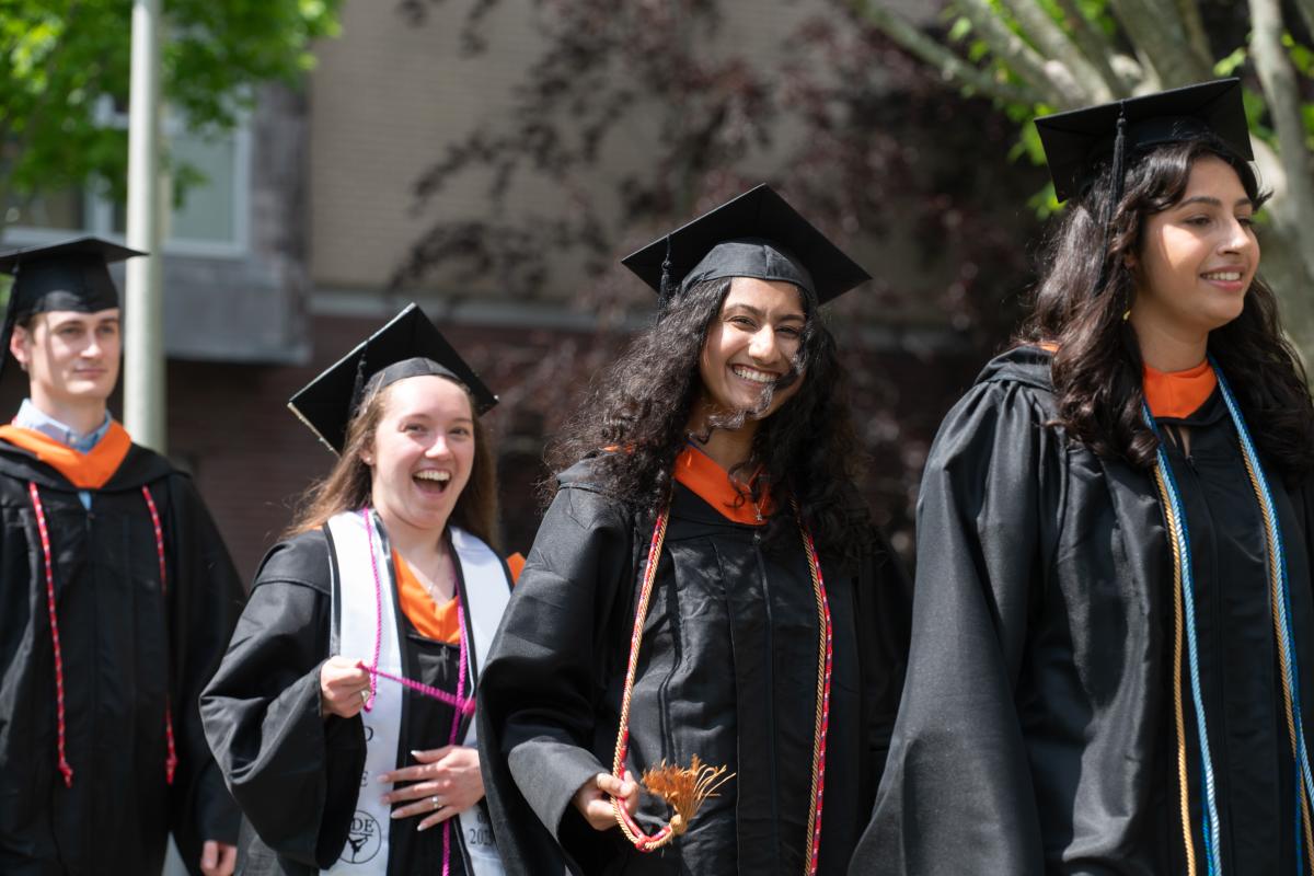 Olin graduates smiles in the procession line at Commencement 2025. 