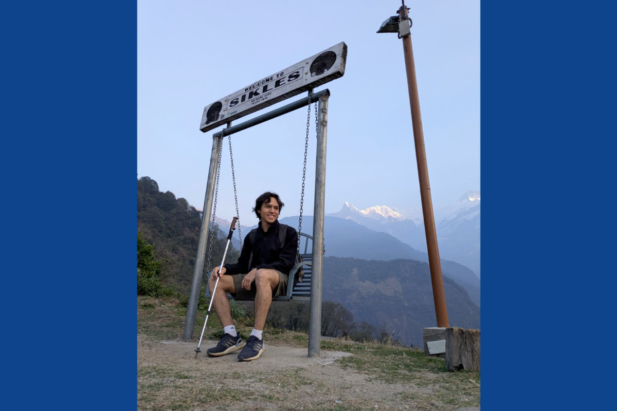 Camilo Cuartas-Lopera in Sikles Camilo Cuartas-Lopera in Sikles, sitting by welcome sign