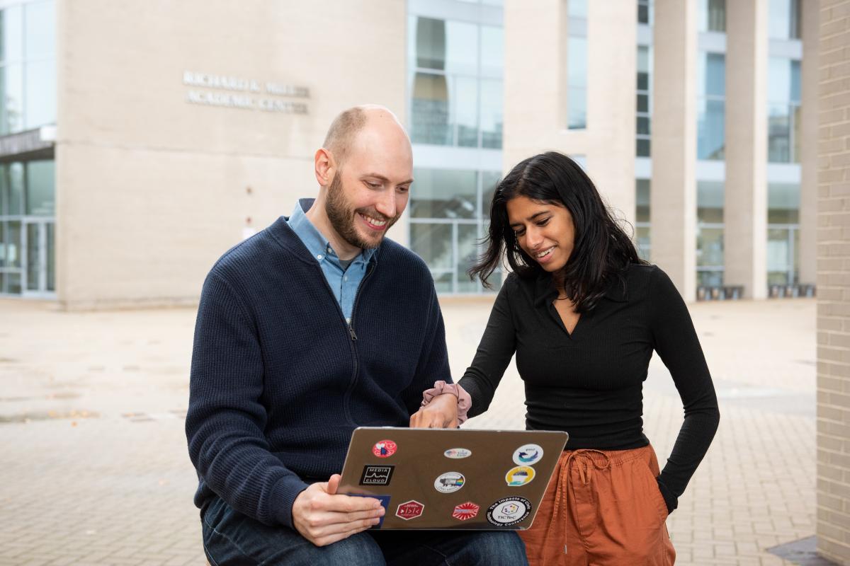 Professor Erhardt Graeff working with student Erhardt working with students in the Oval