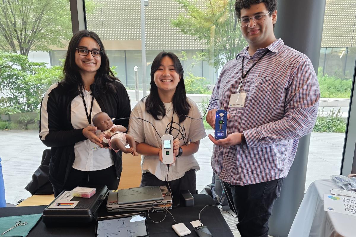 Olin researchers are pictured demonstrating their reprogrammable user interface prototypes that support early detection of hearing loss in children at the Open Healthware Conference in New York City.