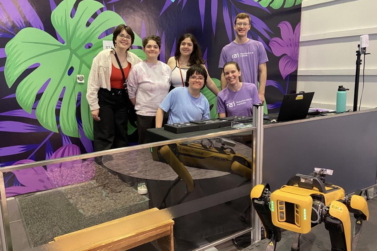 Oliners gather around the robot at the RAI Institute. Oliners gather around the robot at the RAI Institute.