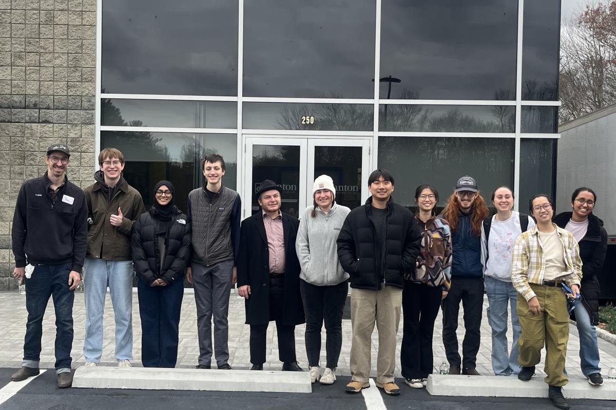 Coby Unger and his co-curricular students stand in front of one of the production bakeries for Dunkin' Donuts.