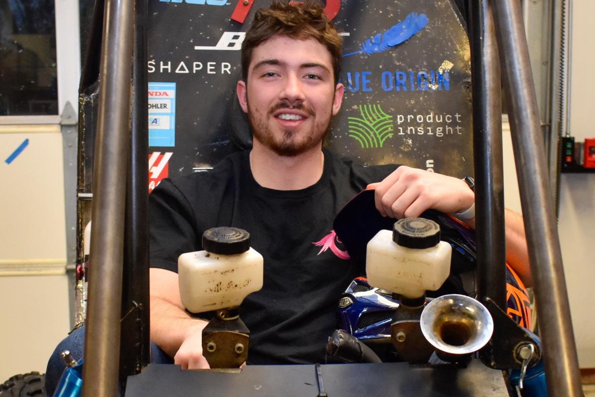 Baja project team lead sits in their car. 