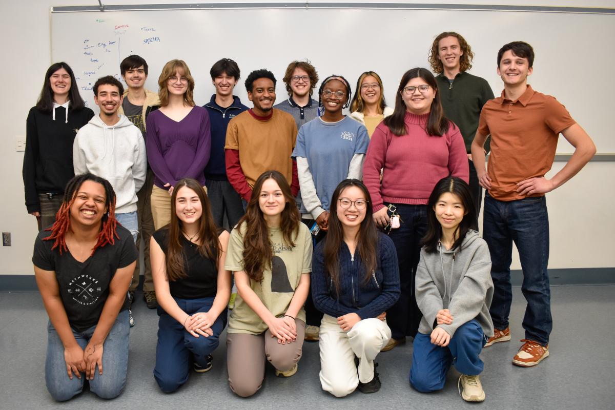 The Olin OAT project team poses in two rows for a group photo in an Olin classroom in front of a whiteboard.