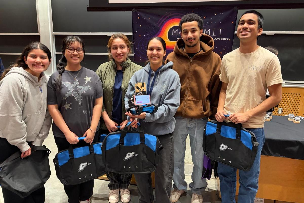 Six college students posing with their hackathon project, McLockin Jr.
