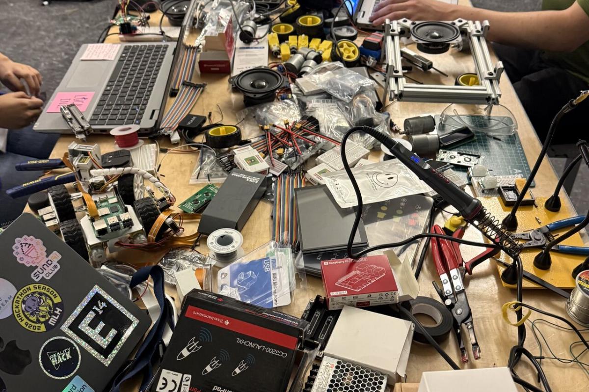 A photo showing electronics and wires strewn across a table.