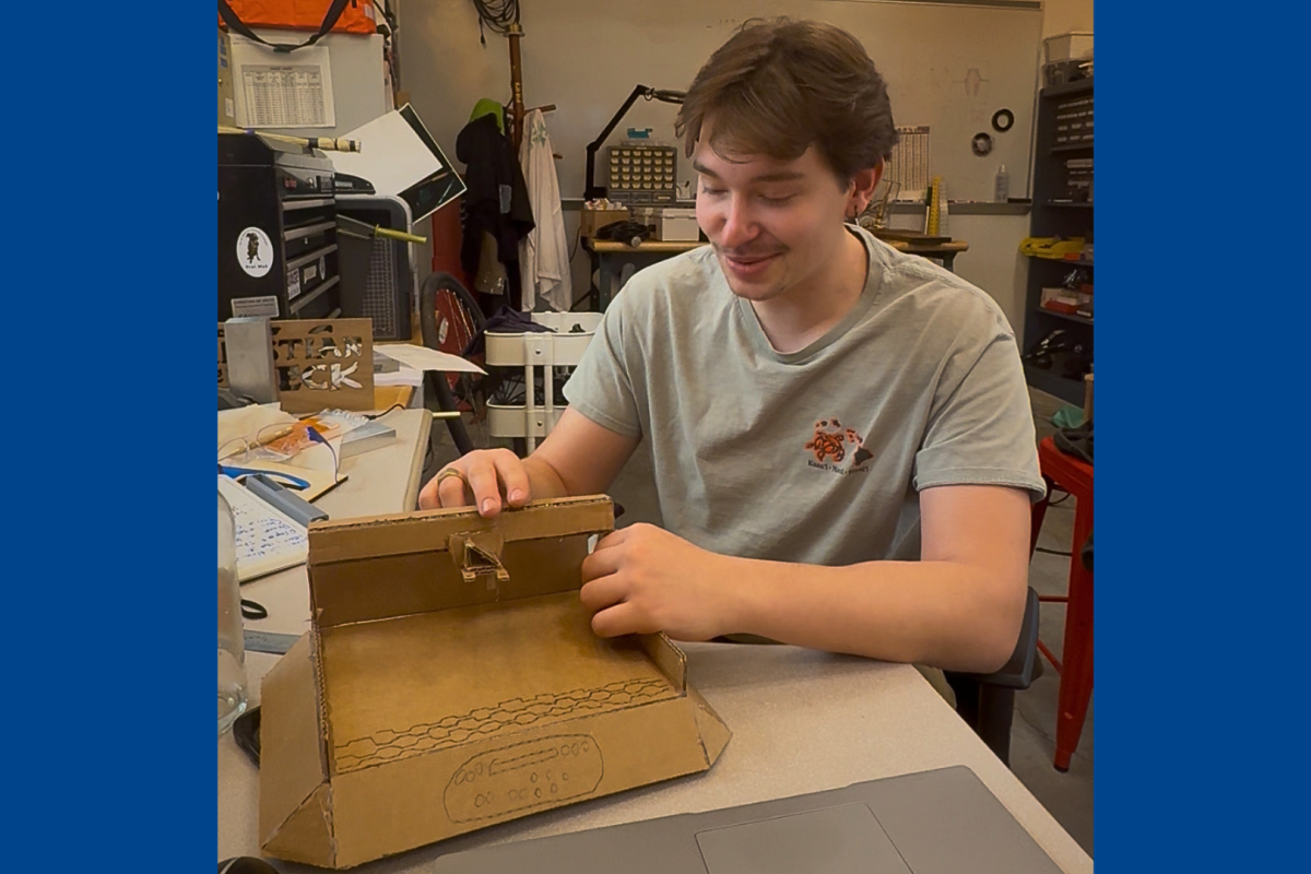 Christian de Weck presents the cardboard prototype for the Build Challenge trophy.