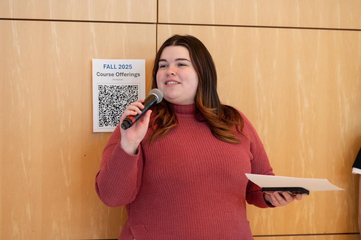 Photo of Jenna Green holding a microphone