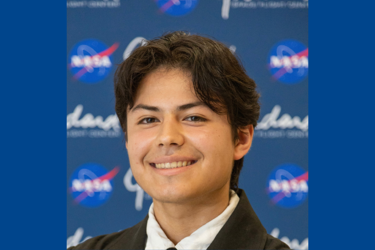 Mateo Otero-Diaz ’28 stands in front of a NASA background.