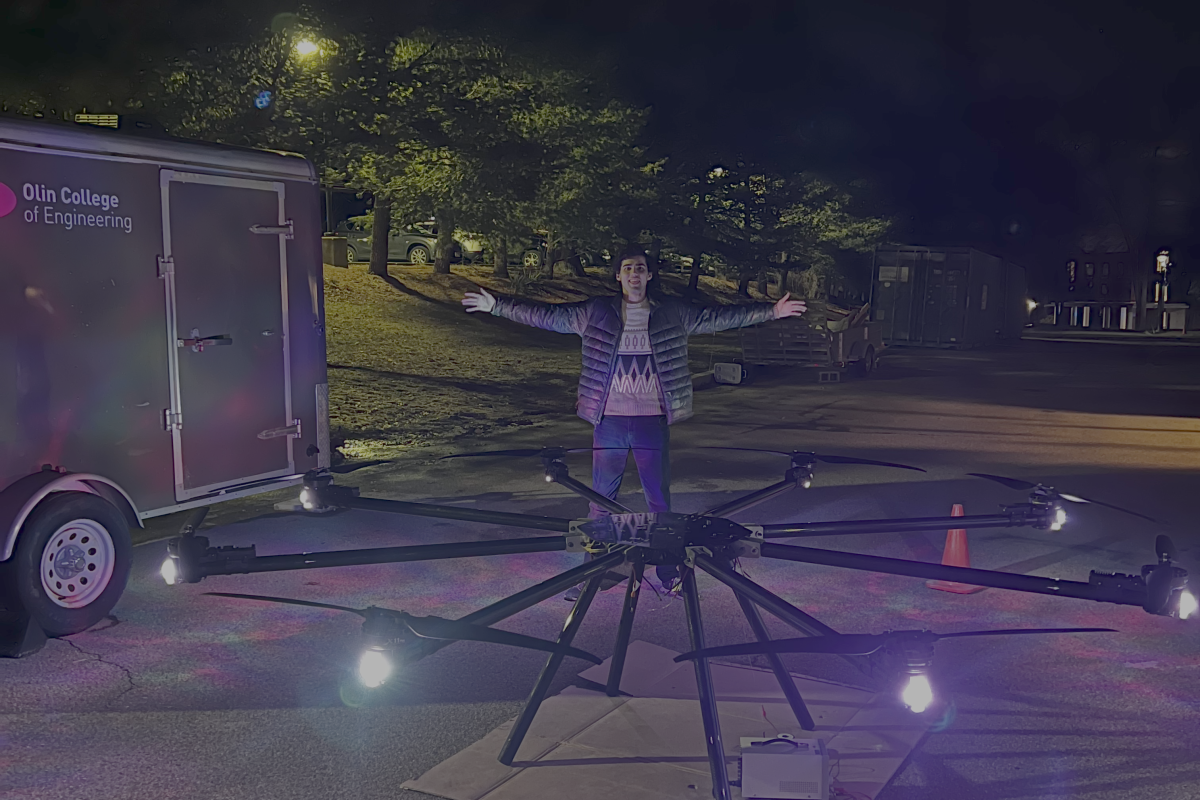 Team lead Ian Walsh '26 poses with OCTAL's firefighting drone.