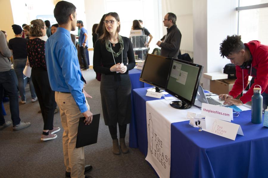 A photo of a employer speaking with a student at a college career fair