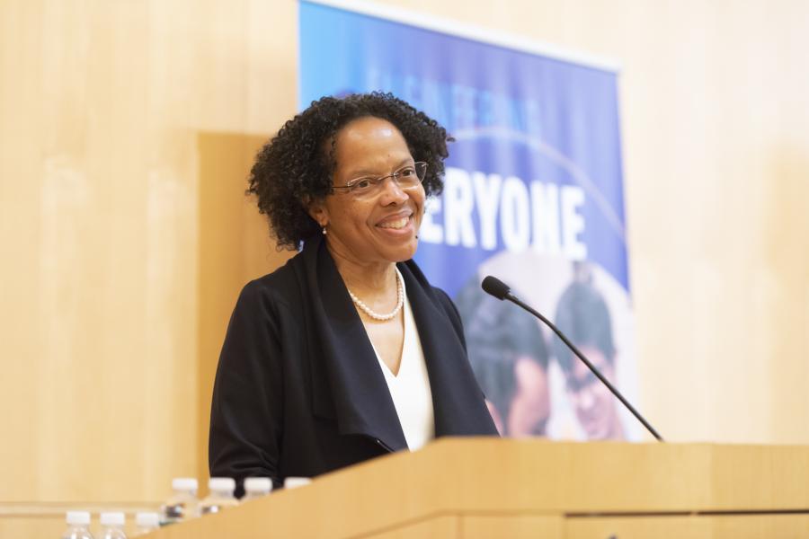 Olin College President Gilda A. Barabino stands at the podium to introduce Frances Haugen '06, an Olin alumna. 