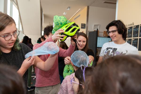 A photo of a group of college students playing with fifth graders from a local elementary school