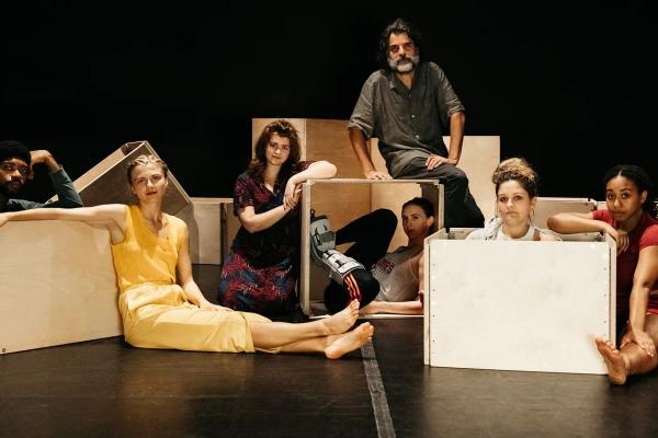 A group of engineering sitting on the floor amist large boxes